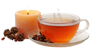Steaming tea and glowing candle creating relaxing atmosphere with transparent background png