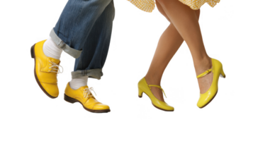 Couple dancing energetically wearing matching yellow shoes on transparent background png