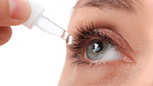 Doctor applying eye drops to patient's eye on transparent background png