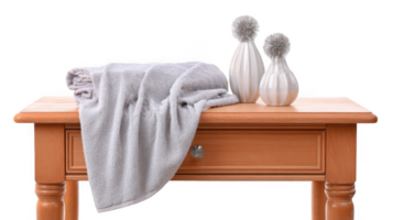 Plush towel draped over wooden vanity with decorative vases on transparent background png
