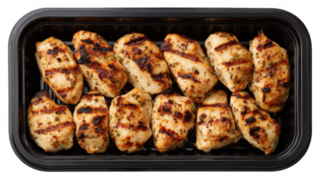 Grilled chicken bites neatly placed in a black plastic tray on transparent background png