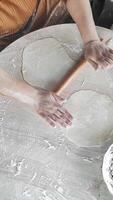 Skillfully Rolling out Dough With a Wooden Pin for Delicious Gozleme Preparation video