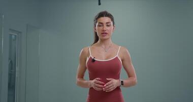 Sporty girl announcer engaged in energetic presentation at a modern studio during a vibrant daytime event video