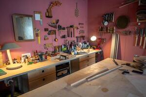 Woodworking studio with organized power tools and clean work surface at day start. Wall tool layout photo