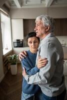 Wife comforting worried husband. Elderly frightened couple hugging supporting each other with love photo