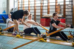 Attentive experienced coach instructs rower crew, correcting posture ensuring synchronized strokes photo