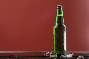 cold green beer bottle comes with refreshing touch. photo