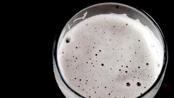 Cold beer with foam in a glass ready to drink photo