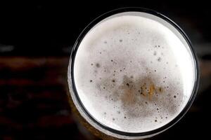 Cold beer with foam in glass ready to drink. photo