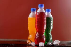 Soft drink bottle red background photo