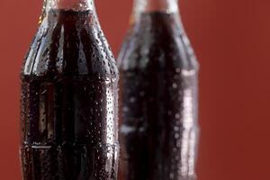 Soft drink bottle red a background photo