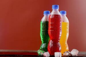 Soft drink bottle with a red background photo