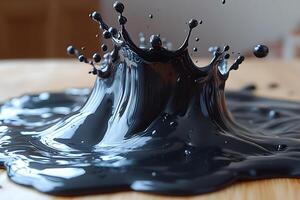 Dynamic Splash of Glossy Black Liquid on Wooden Surface for Creative Design photo