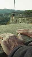 Hands Of Elderly Man Resting on a Panoramic View at Sunset At Historic Village Outside video