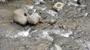 water flows in the river between the rocks photo