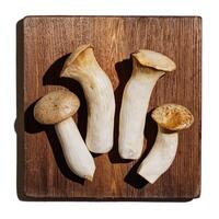 Pleurotus eryngii white mushrooms on wooden board, edible fungus in minimal style on beige background, top view aesthetic food photo, flat lay from whole mushroom, health eating, vegetarian food photo