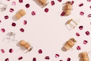 Pattern of champagne corks and bright confetti on pastel color background with sunlight shadow, sun glare. Trend layout of bottle cap cork, top view, minimal flat lay, holiday, celebrate concept. photo