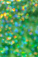 Green yellow Defocused abstract bokeh background pastel hues, flare from lights, color gradient, blurred round bokeh as holiday texture. Glittering aesthetic textured lighting photo