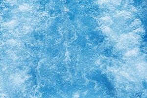 Bubbling water texture, flow thermal water as abstract background macro photo, spa and wellness theme, gentle ripples and gurgling on white blue aquatic surface, sea color gradient photo