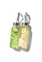 Glass bottles with lemon, cucumber water drink detox at sunlight on white background, copyspace. Healthy infused water boost metabolism, weight loss. Aesthetic still life, refreshing drink photo