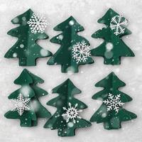 Winter Holidays decor, Christmas trees from green craft paper, Christmas and New Year flat lay. Handmade fir decorated snowflakes on white fur background. Top view creative trend pattern, snow photo