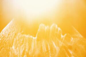 White shiny glare from sunlight on yellow background, abstract nature photo with sunshine flare, vivid color minimal aesthetic light effect, optical blur glow, defocused natural backdrop