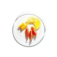 Transparent glass plate with slices of fruit as lemon, orange, red tangerine isolated on white background. Beautiful shadow at sunlight, top view design object, colorful fresh juicy slices of fruit photo