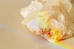 Quartz Prism Rainbow Reflection at sunlight, close up of clear quartz crystal captures prismatic rainbow, natural facets and beauty of mineral. Minimal aesthetic nature pattern, beige pastel tone photo