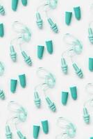 Different earplugs as minimal pattern, comfort silicone and rubber ear plug on string protection against noise, protect hear, for swim, sleep, rest. Top view flat lay photo pattern