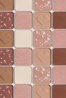 Minimal tren pattern of eye shadow beige tones swatches, monochrome photo background, eyeshadow with heart imprint, shiny natural shades powder makeup, square shape metal pack, beauty cosmetic texture