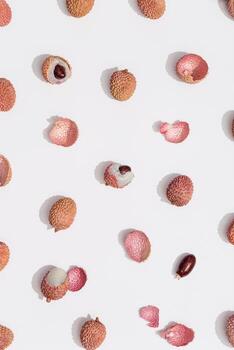 Pattern with fresh Lychee fruit on white background. Minimal fruit and summer concept. photo