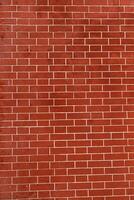 Brick wall is bright red, texture of stone blocks, background of bricks. photo