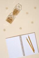 Top view of open school notebook with blank pages, hourglass and pencils. Workspace home with autumn shades. photo