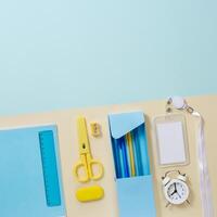 School stationery in yellow and blue tone. Office accessories study and educational flat lay. photo