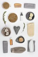 Bath accessories from natural material, bottle with gel or shampoo, soap, hairbrush, washcloth, branch of eucalyptus photo