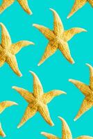 Bright summer pattern with sea stars. Yellow starfish on turquoise, sea summer vacation concept. photo
