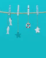 Marine or nautical themed background, summer sea toys lifeline, starfish and small fish hanging photo