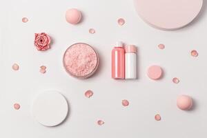 Aromatic crystals of sea salt with essential oil flower of rose. Spa composition with cosmetic bathroom product top view photo
