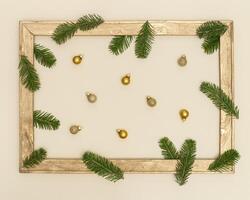 Christmas background with retro wooden frame with green fir branches and golden christmas balls photo