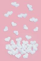 Valentines Day background with white hearts on pink colored. Greeting card or invitation for wedding cards. photo
