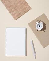 Autumn working space with open notebook with blank pages and white clock show day time. Autumnal time and mood concept photo