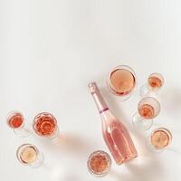 Rose wine assortment in crystal glasses, bottle of rose champagne sparkling wine. Summer alcoholic drink. photo