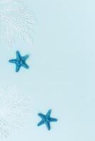 Summer flat lay with starfishes and coral on blue background. Summertime or beach concept photo