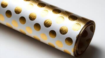 Elegant roll of wrapping paper featuring a white background adorned with shimmering golden polka dots design photo
