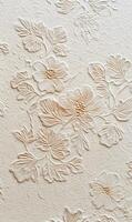 Elegant floral wallpaper featuring delicate embossed flowers adding texture and depth to a creamy surface beauty blooms photo