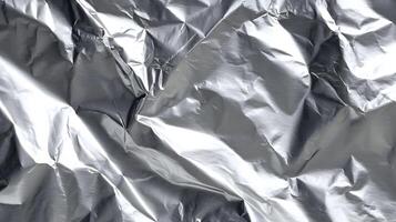 Metallic brilliance unfolds in a textured dance of light and shadow on crumpled foil surface texture photo