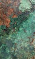 Oxidized metal surface displaying verdigris and rust providing a unique textured pattern of corrosion design photo