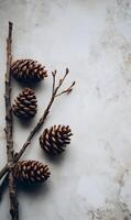 Rustic autumn composition with pine cones and branches on a textured surface creating a natural ambiance photo