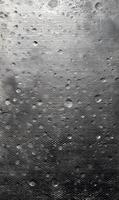 Abstract glistening metallic surface exhibiting an array of scattered water droplets texture background, creating an intriguing visual narrative of light and reflection photo