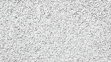 Detailed white textured surface with black specks creating a rough backdrop for graphic design use photo